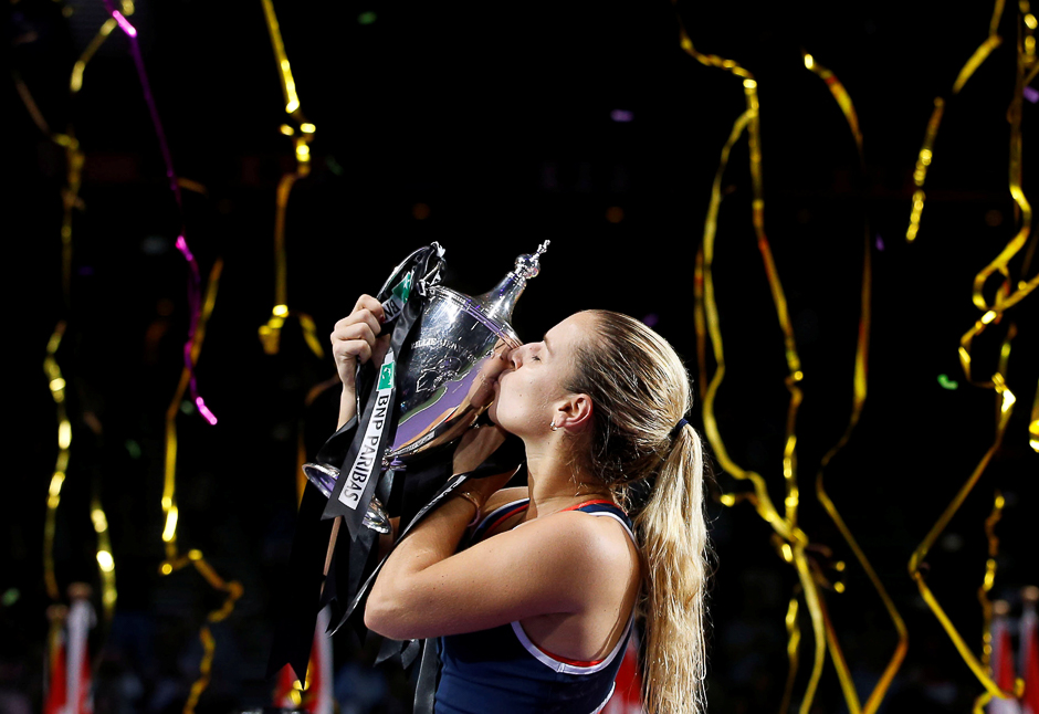 Dominika Cibulkova of Slovakia celebrates with her trophy after defeating Angelique Kerber of Germany. PHOTO: REUTERS