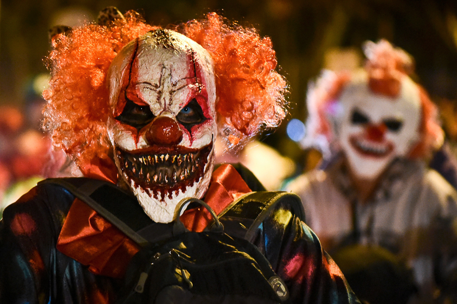 Participants dressed as clowns take part in a 