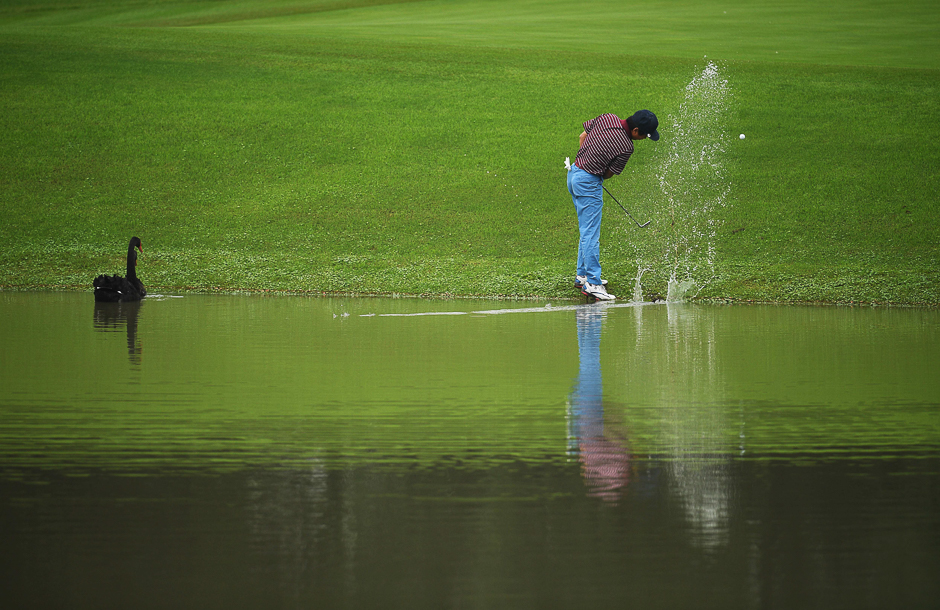 Xiong Zong of China hits his ball out of the water during the ProAm event for the World Golf Championships-HSBC Champions golf tournament in Shanghai. PHOTO: AFP