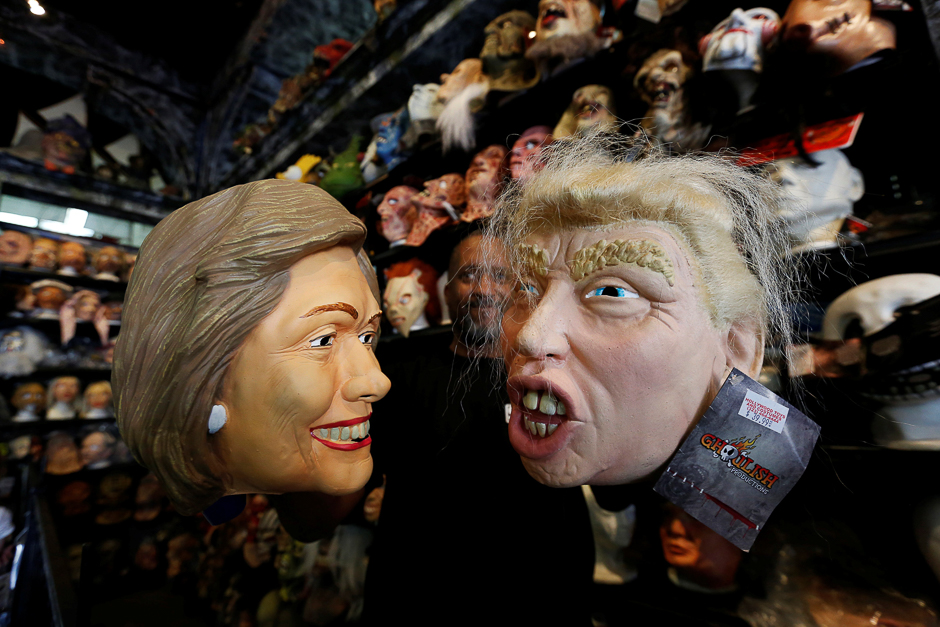 Masks are seen depicting Hilary Clinton and Donald Trump in a toy store in Los Angeles, US. PHOTO: REUTERS