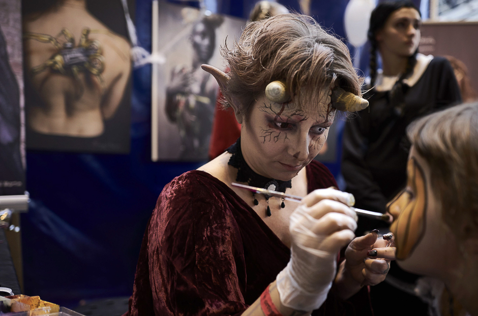 A tattoo artist works on a tattoo on a woman's arm during the second edition of the Halloween Tattoo Convention in Givors, east-central France. Around 50 tattoo artists from France took part in the two-day event, that offered shows, concerts and exhibitions ahead of Halloween. PHOTO: AFP