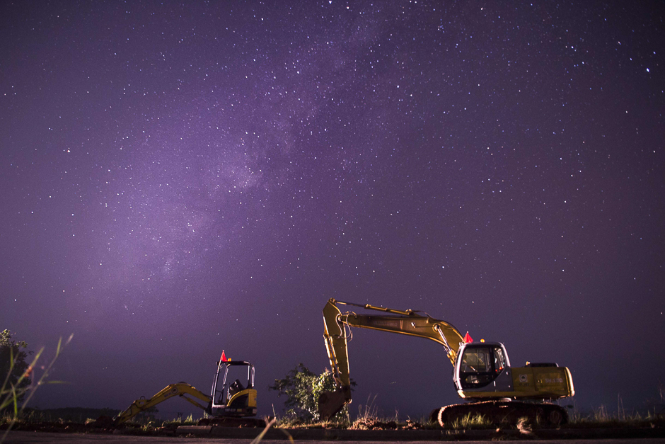 This long-exposure photograph shows the Milky Way in the clear night sky over a construction site along the Yangon-Naypyidaw Highway.