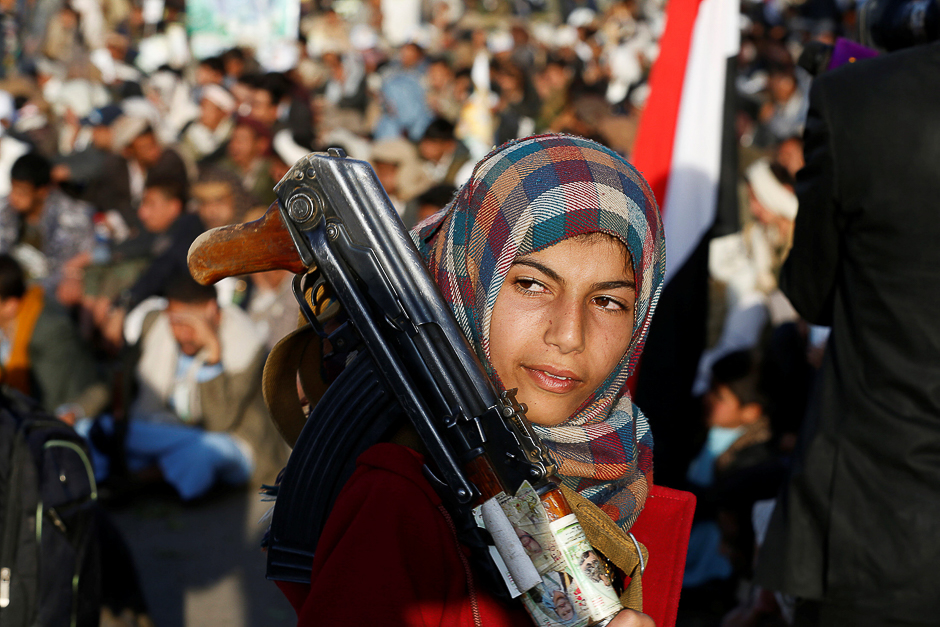 A girl carries a rifle as she attends a rally by followers of the Shi'ite Houthi movement commemorating the death of Imam Zaid bin Ali in Sanaa, Yemen. PHOTO: REUTERS