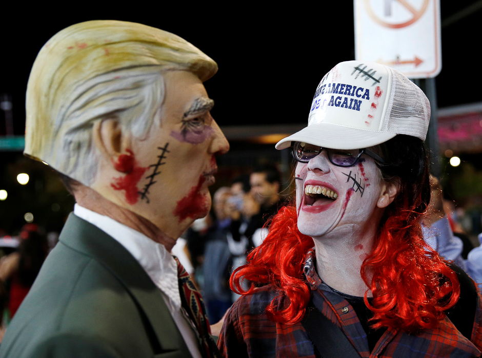 Zombies clamor for wig mannequins during the annual Silver Spring Zombie Walk before Halloween in Silver Spring, Maryland, US. PHOTO: REUTERS