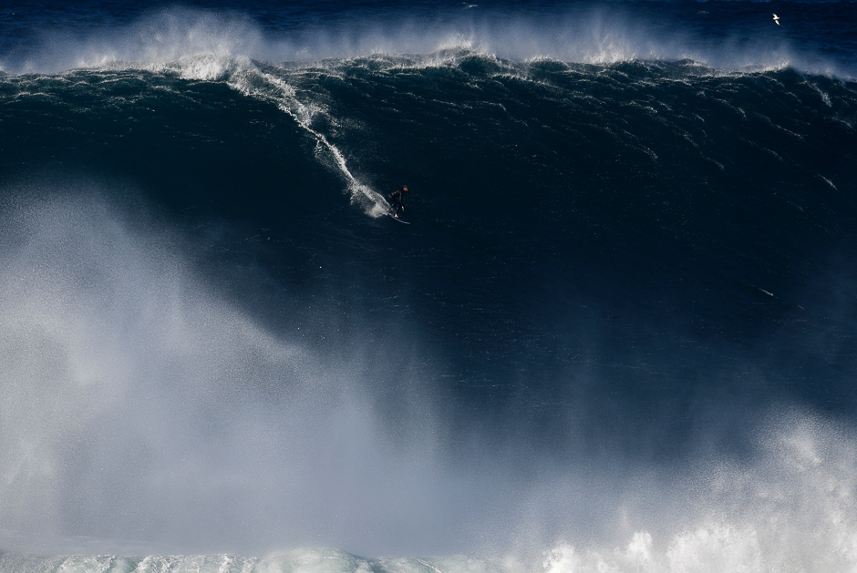 A surfer rides a wave off Praia do Norte (North Beach) near Nazare, central Portugal. PHOTO: AFP