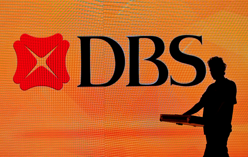A worker walks past a DBS logo before an event in Mumbai, India. PHOTO: REUTERS