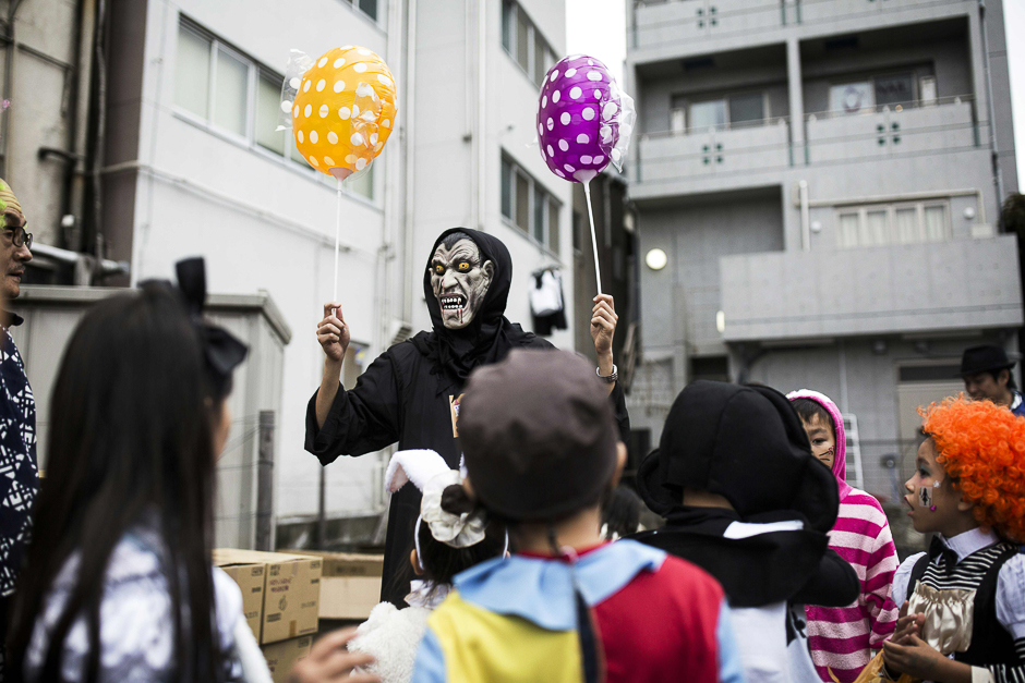 Japanese people in costumes gesturing as they take part in a Halloween parade in Tokyo. Tokyo nursed a giant pumpkin-sized hangover on October 31 after a weekend of Halloween revelry which saw blood-spattered ghouls, fluffy animals and 'terrifying' presidential candidates cut loose. PHOTO: AFP
