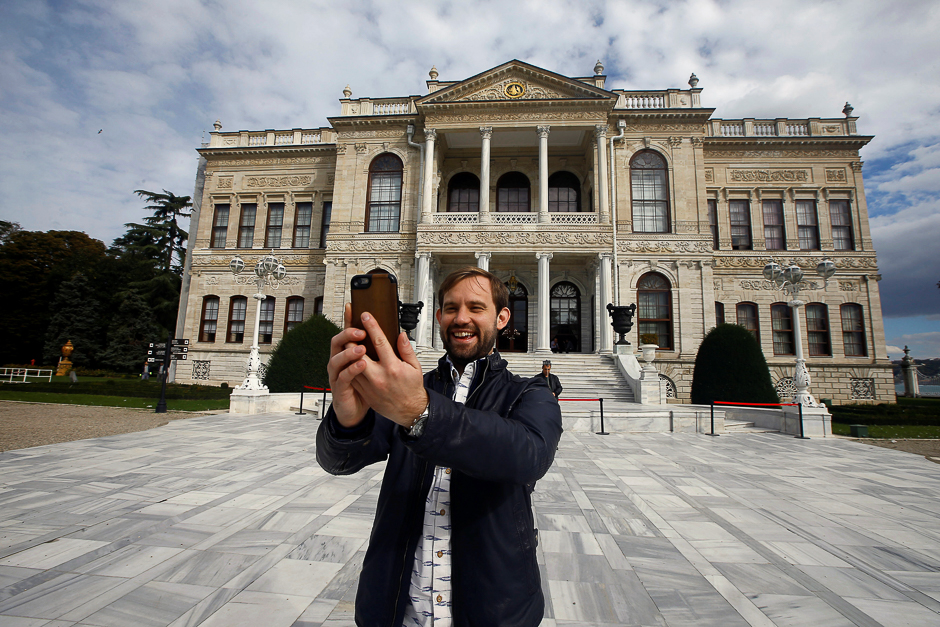 Naz Osmanoglu, a British comedian and member of Turkey's former ruling family, poses at the entrance of the Ottoman-era Dolmabahce Palace in Istanbul, Turkey. PHOTO: REUTERS