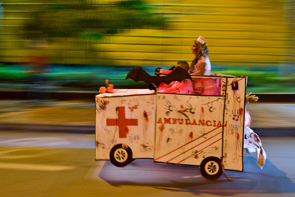 A couple drive a motorcycle decorated as an ambulance during a 