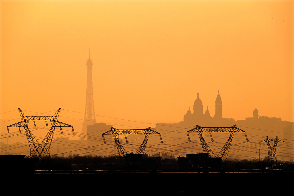 Electricity pylons of high-tension electricity power lines are seen in front of the Eiffel Tower, France. PHOTO: REUTERS