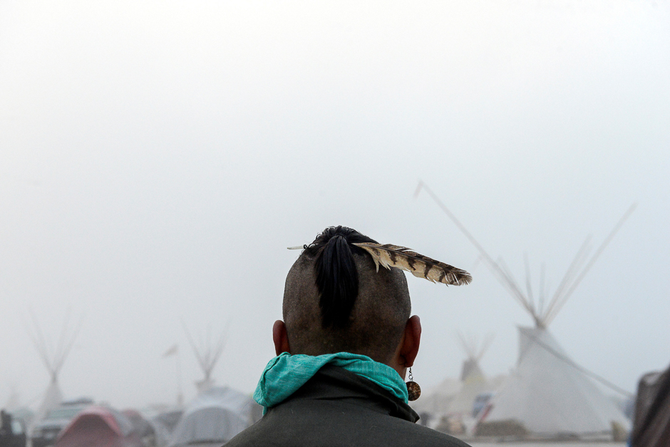 A man from the Muskogee tribe looks at the Oceti Sakowin shrouded in mist during a protest against the Dakota Access pipeline near the Standing Rock Indian Reservation near Cannon Ball, North Dakota, US. PHOTO: REUTERS