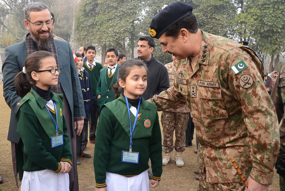 Gen Raheel Sharif (R) speaking with students at the Army Public School after it was reopened following an attack there by Taliban militants in Peshawar. PHOTO: ISPR