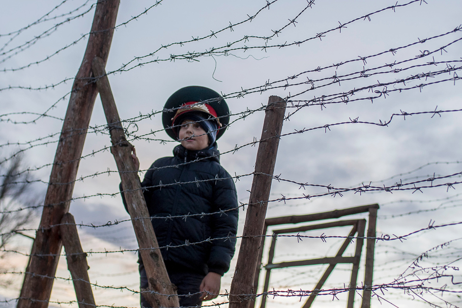 Matus, a seven-year-old Slovak boy, wears a Soviet military hat as he stands by remains of the border fences from the former 'Iron curtain' near Bratislava, Slovakia. PHOTO: AFP