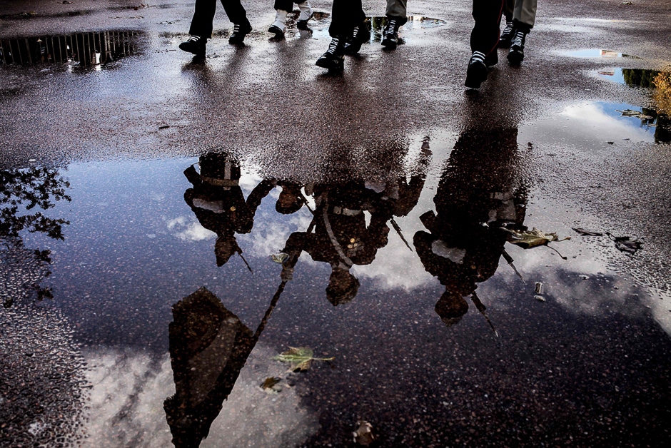 French soldiers taking part in a military parade are reflected in pools of rainwater in a street of Lyon, central eastern France, during the Armistice Day ceremony marking the 98th anniversary of the end of World War I. PHOTO: AFP