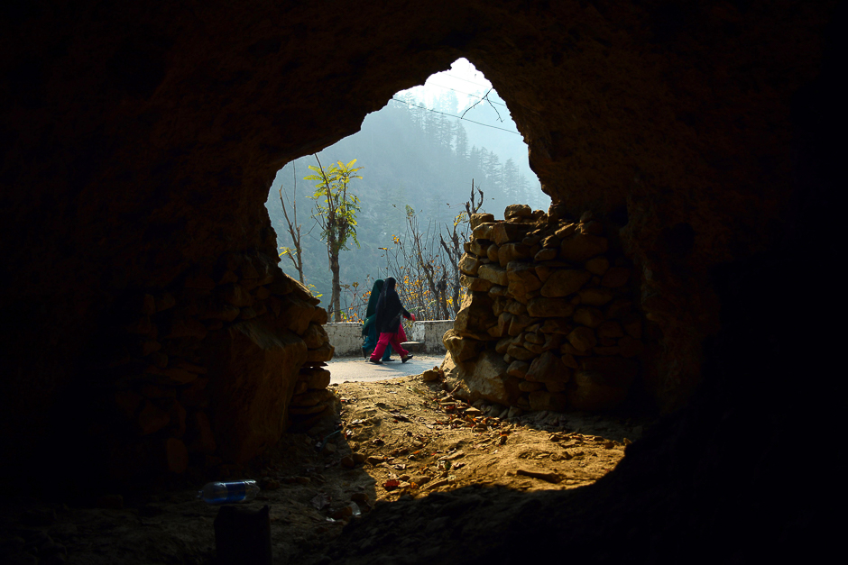 Pakistani Kashmiri women walk past a bunker in Athmuqam village at the Line of Control, the de facto border between Pakistan and India, in Neelum Valley of Pakistan-administered Kashmir. PHOTO: AFP