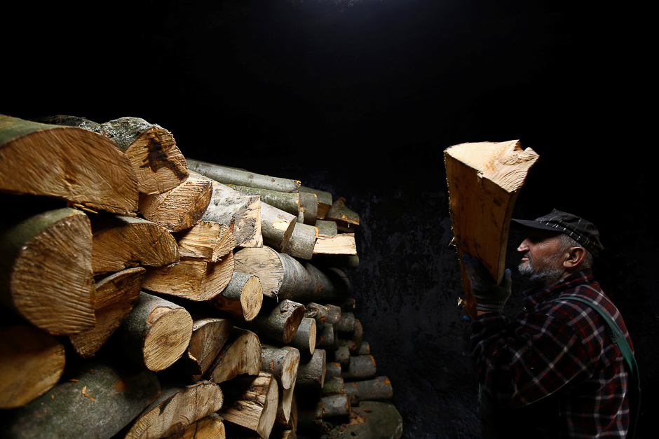 Charcoal burner Zygmunt Furdygiel loads wood into a charcoal furnace at a charcoal making site, in the forest of Bieszczady Mountains, near the village of Baligrod, Poland. PHOTO: REUTERS