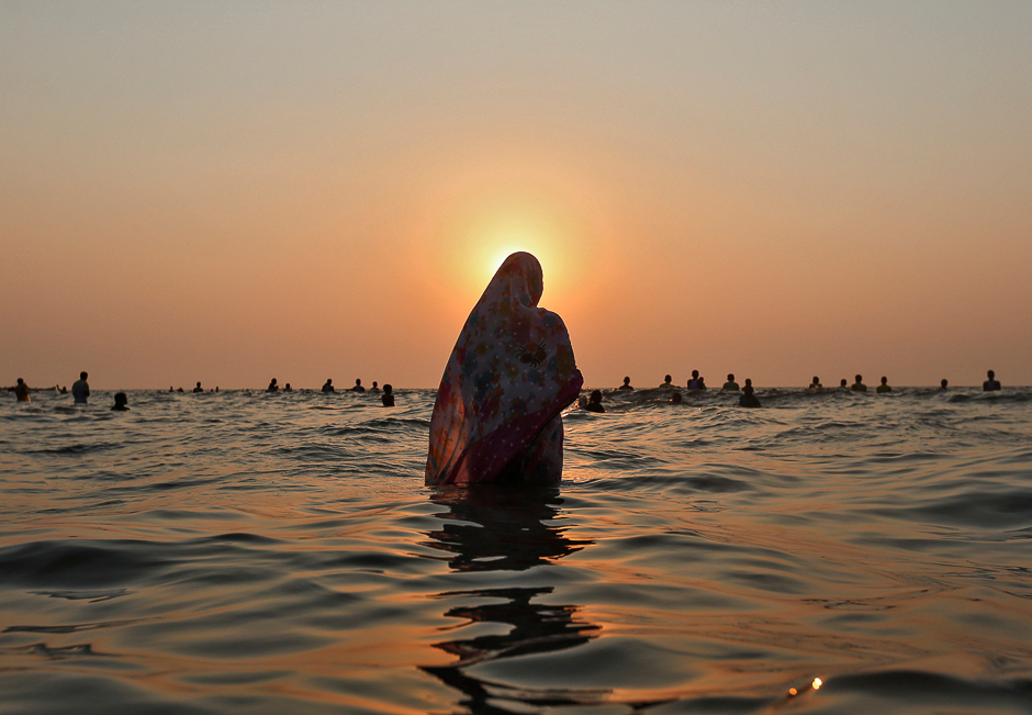 Hindu devotees worship the Sun god in the waters of the Arabian Sea during Chhath Puja in Mumbai, India. PHOTO: REUTERS