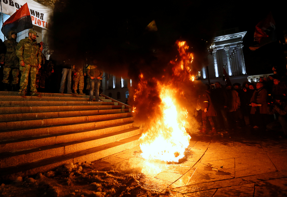Activists of nationalist groups and their supporters burn tyres in Independence Square as they gather to mark the anniversary of the 2014 Ukrainian pro-European Union (EU) mass protests on the Day of Dignity and Freedom in central Kiev, Ukraine. PHOTO: REUTERS