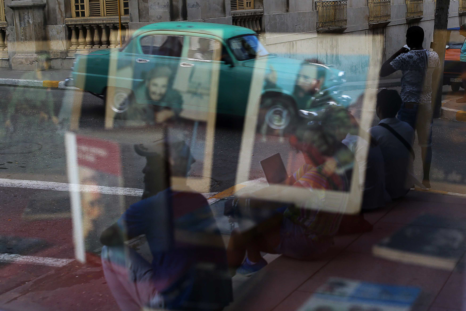 Portraits of Fidel Castro are reflected in a window in Matanzas, Cuba. PHOTO: REUTERS