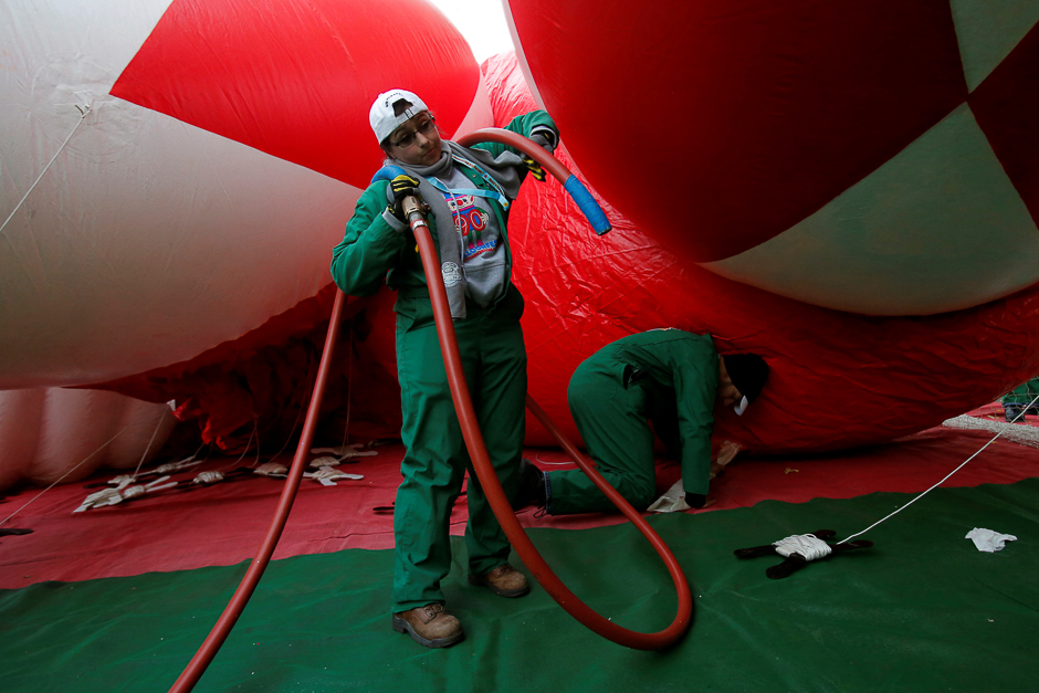 Members of the Macy's Inflation Team work on the Red Mighty Morphin Power Ranger balloon ahead of the 90th Macy's Thanksgiving Day Parade in Manhattan, New York, US. PHOTO: REUTERS