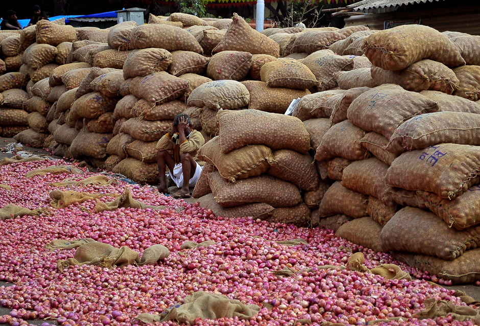 A vendor waits for customers at a wholesale onion market in Bengaluru, India. PHOTO: REUTERS