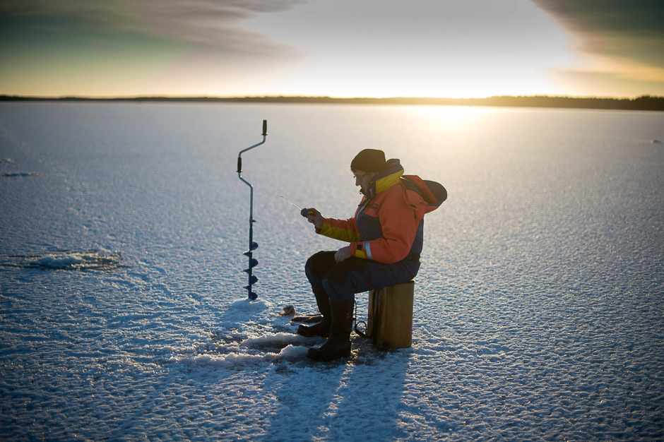 A man is ice-fishing at midday on the frozen Bothnia Sea in Vaasa, Western Finland. PHOTO: AFP