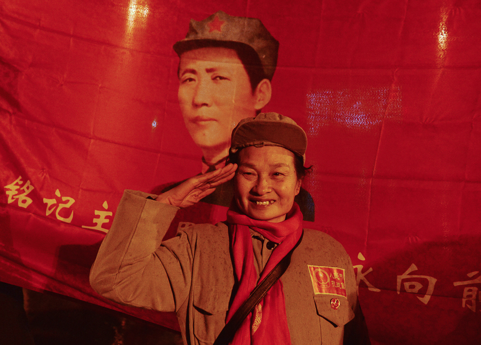 A woman salutes as people gather to celebrate China's late chairman Mao Zedong's 123rd birth anniversary in Shaoshan, Hunan province. PHOTO: REUTERS
