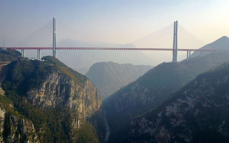 This picture shows the Beipanjiang Bridge, near Bijie in southwest China's Guizhou province. The world's highest bridge has opened to traffic in China, connecting two southwestern provinces and reducing travel time by three quarters, local authorities said. PHOTO: AFP