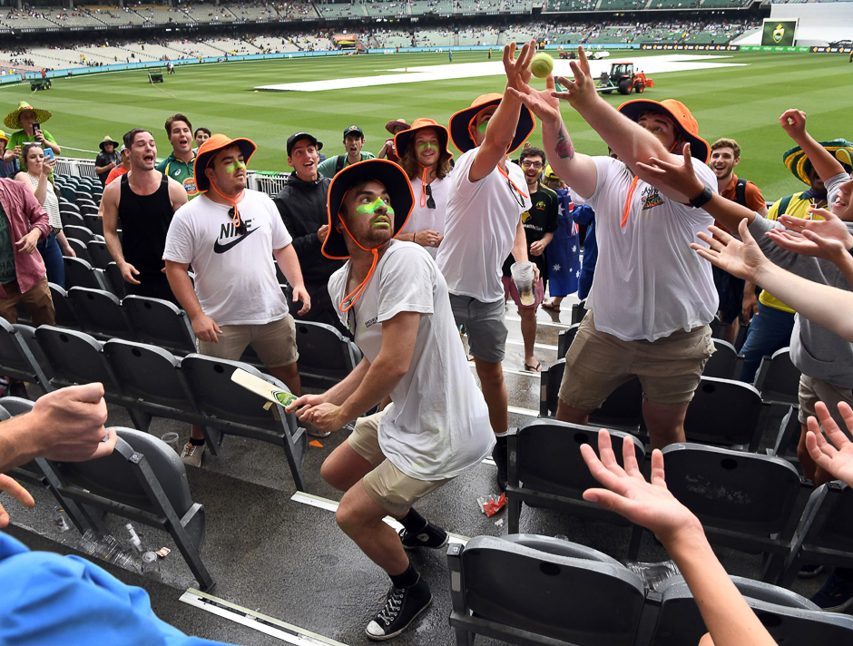 Spectators play an improvised game of cricket in the stands as rain forces Australia and Pakistan from the ground on the second day of the second cricket Test match in Melbourne. PHOTO: REUTERS