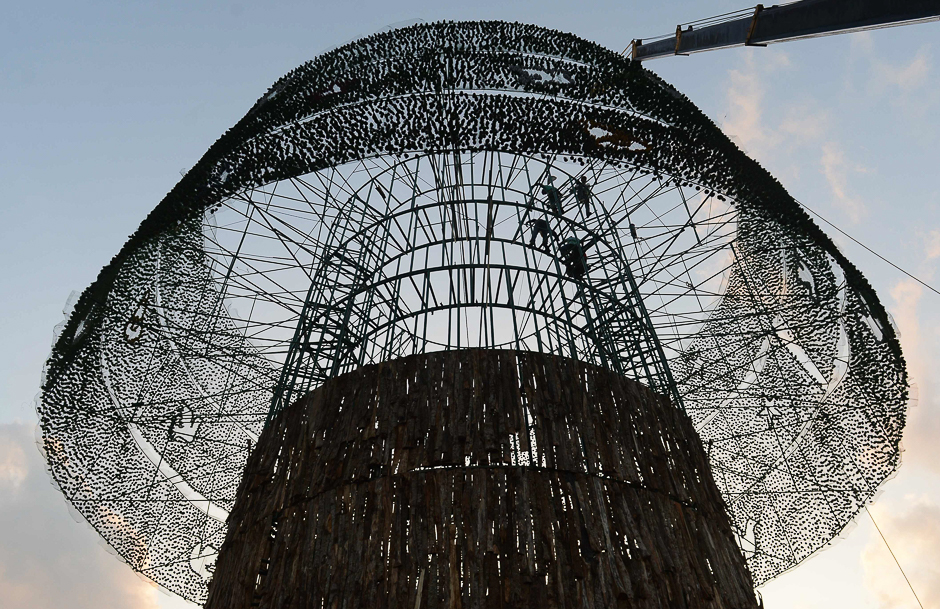 Sri Lankan construction workers prepare a partially constructed Christmas tree in Colombo. PHOTO: AFP