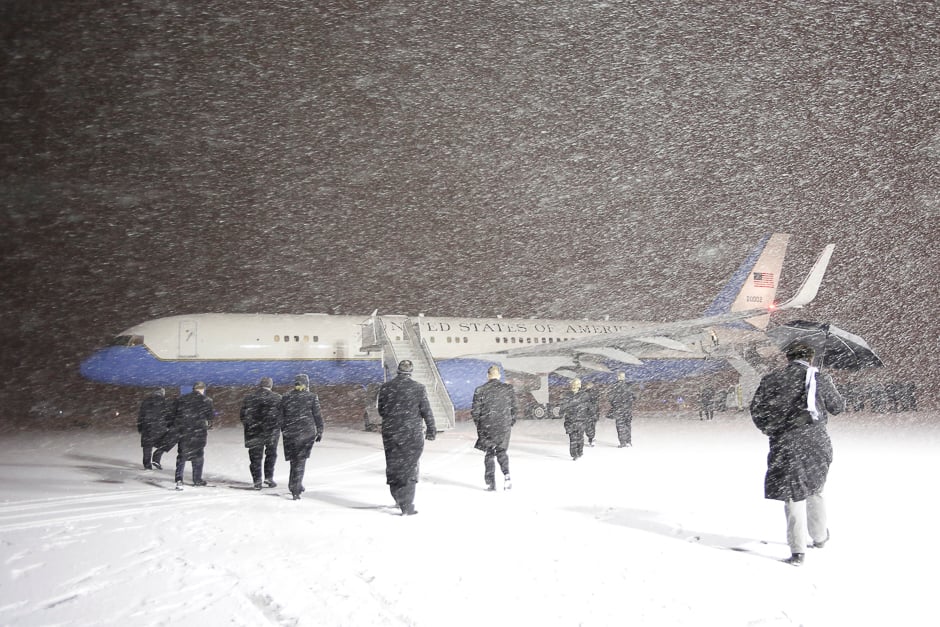 Officials walk out towards the plane carrying U.S. Vice President Joe Biden upon his arrival in a snow storm at the Ottawa International Airport in Ottawa, Ontario, Canada, December 8, 2016. REUTERS/Chris Wattie