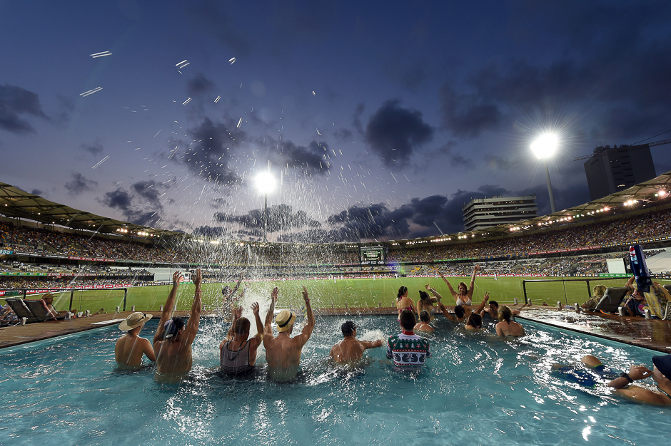 Spectators cheer inside a pool during the first day-night cricket Test between Australia and Pakistan at the Gabba in Brisbane. PHOTO: AFP