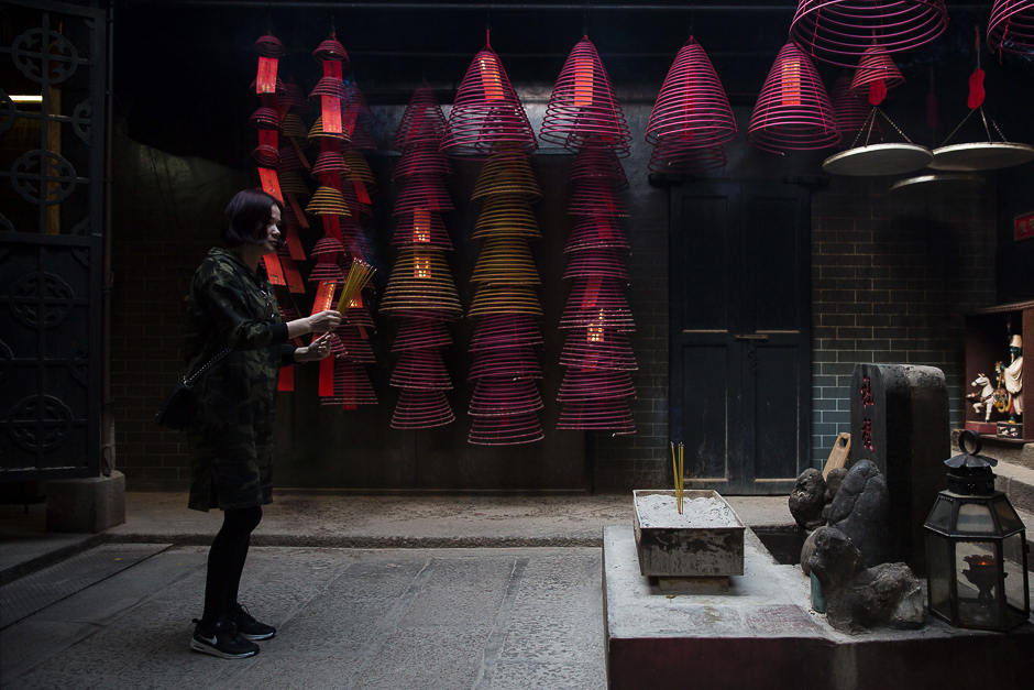 A women makes an offering with joss sticks at a temple in the Yau Ma Tei district of Hong Kong. PHOTO: AFP