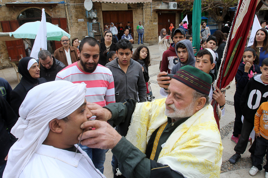 A Lebanese Muslim Sufi young man has a spike pierced into his cheek during a ritual ceremony. PHOTO: AFP