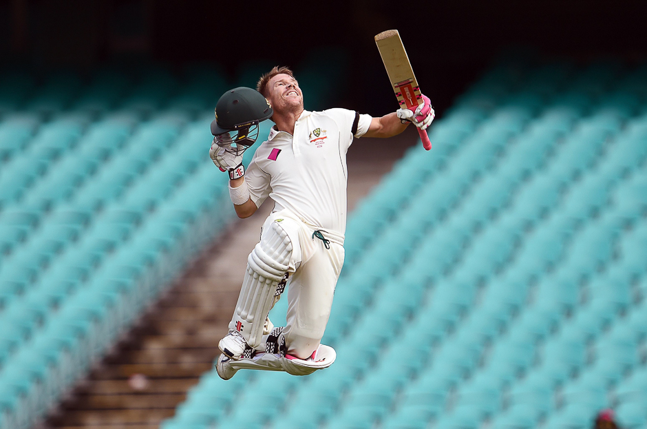 This file photo taken on January 07, 2016 shows Australia's batsman David Warner leaping in the air after scoring his century against the West Indies on the final day of the third cricket Test match in Sydney. PHOTO: AFP