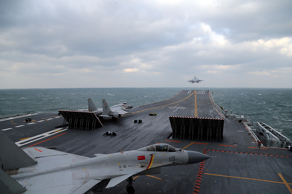 The photo shows Chinese J-15 fighter jets on the deck of the Liaoning aircraft carrier during military drills in the Yellow Sea, off China's east coast. PHOTO: AFP