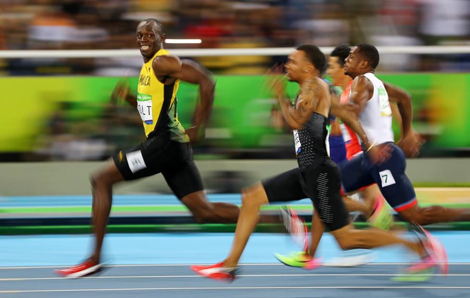 Usain Bolt of Jamaica looks at Andre De Grasse of Canada as they compete in the men's 100m semifinals at the Rio Olympics August 14, 2016. PHOTO: REUTERS