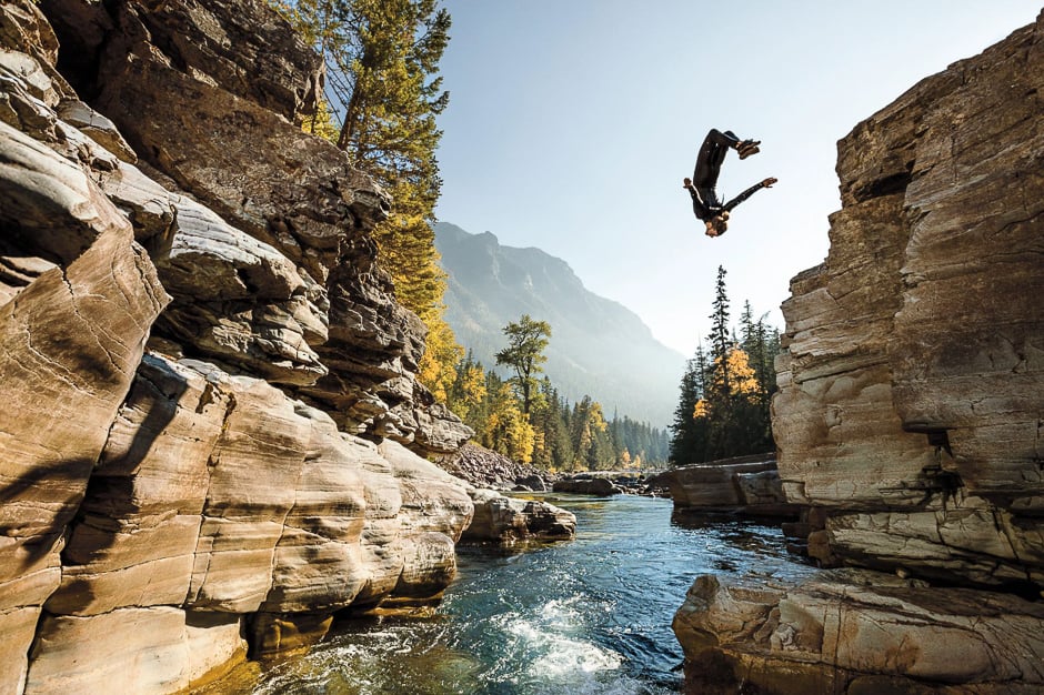 Steven Donovan, flipping into a pool, took a seasonal job at Glacier National Park to sharpen his photography skills. PHOTO: COREY ARNOLD/NATIONAL GEOGRAPHIC