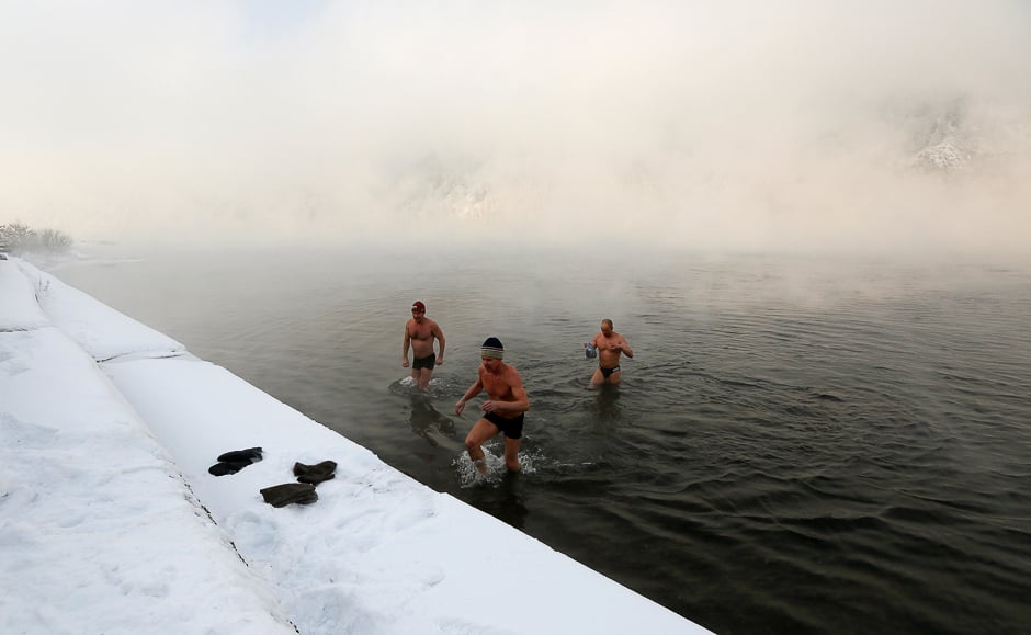 Enthusiasts of winter swimming walk out of the icy waters of the Yenisei River after their weekly bathing session, with the air temperature at about minus 30 degrees Celsius (minus 22 degrees Fahrenheit), in the Siberian town of Divnogorsk, Russia November 18, 2016. REUTERS/Ilya Naymushin