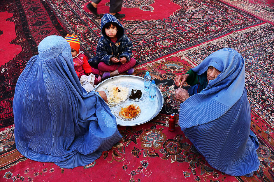 Afghan women and children eat during celebrations in Afghanistan. PHOTO: AFP