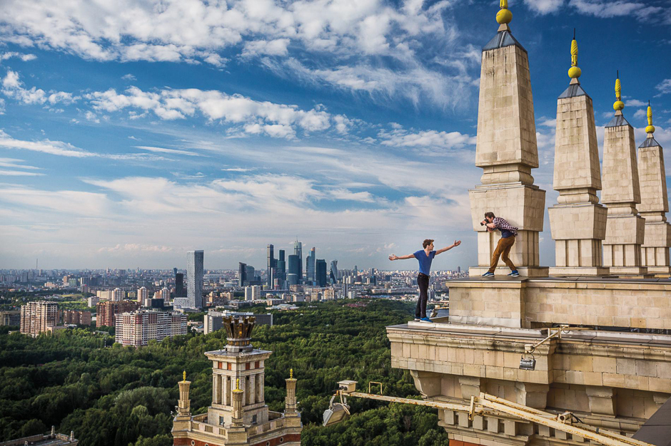 Kirill Vselensky perches on a cornice in Moscow as Dima Balashov gets the shot. The 24-year-olds, risktakers known as rooftoppers, celebrate their feats on Instagram. PHOTO: GERD LUDWIG/NATIONAL GEOGRAPHIC