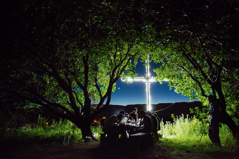 Villagers in Bagaran, Armenia, sing of cultural endurance and survival while picnicking at night beneath apricot treesâand a giant cross that shines defiantly into Turkey. PHOTO: JOHN STANMEYER/NATIONAL GEOGRAPHIC