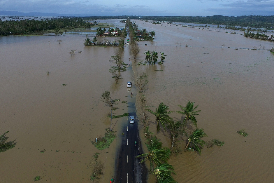 An aerial photo shows a flooded highway after typhoon Nock-Ten made landfall in Polangui, Albay province on December 26, 2016. Typhoon Nock-Ten, which made landfall on the eastern island province of Catanduanes on December 25, is forecast to move westward towards the country's heartland, packing winds of 215 kilometres (134 miles) per hour. PHOTO: AFP