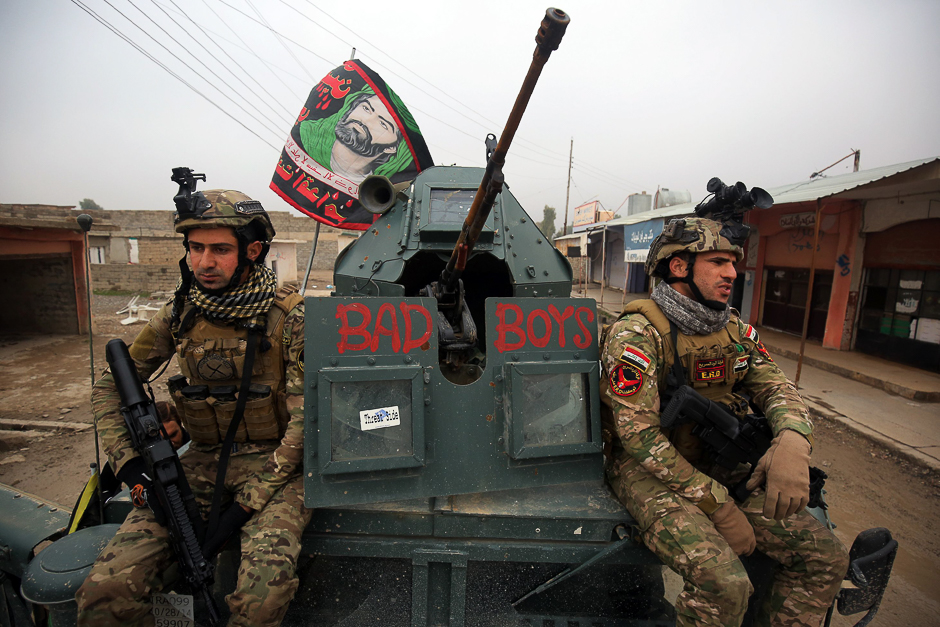 Iraqi pro-government forces patrol in the eastern part of the embattled Iraqi city of Mosul, during an ongoing military operation against Islamic State (IS) group militants. PHOTO: AFP