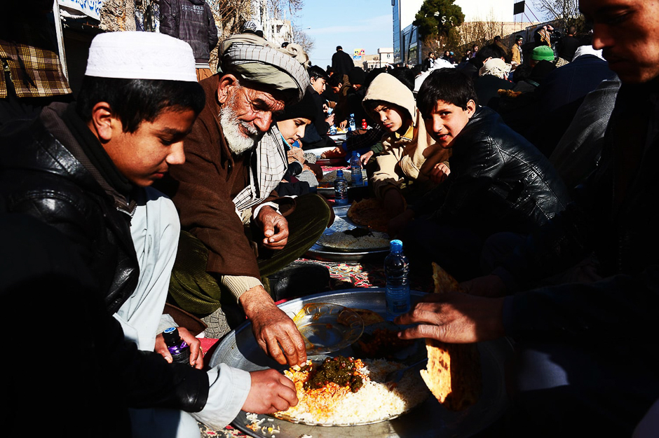 Afghan men and boys eat during celebrations in Afghanistan. PHOTO: AFP