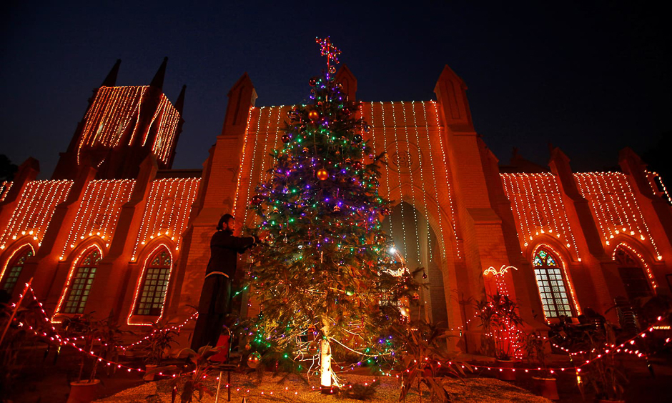 A man decorates a Christmas tree at the St. John Cathedral Church ahead of Christmas celebrations in Peshawar, Pakistan, December 24, 2016. REUTERS/Fayaz Aziz