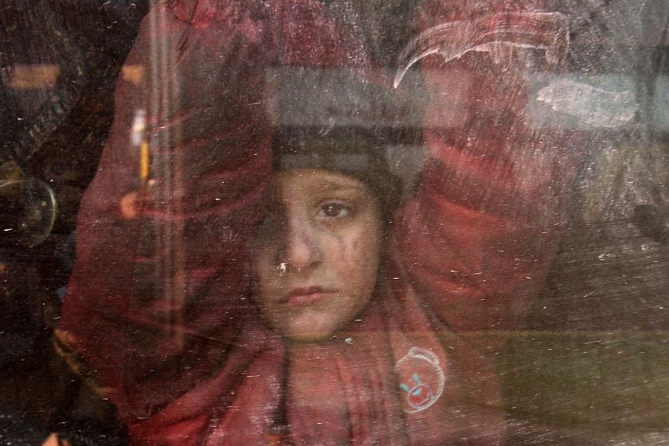 A boy rides a bus to be evacuated from a rebel-held sector of eastern Aleppo. PHOTO: REUTERS
