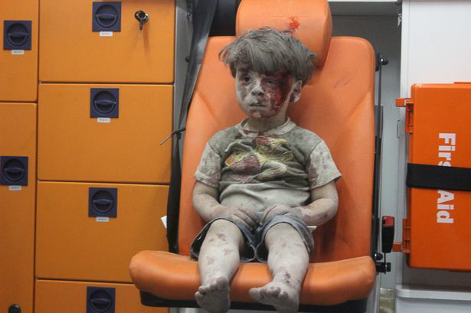 A picture of 5-year-old Omran Daqneesh, with bloodied face, sits inside an ambulance after he was rescued following an airstrike in the rebel-held al-Qaterji neighbourhood of Aleppo. PHOTO: REUTERS