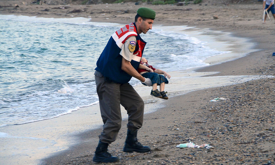 A paramilitary police officer carries the lifeless body of Alan Kurdi off the coast of Bodrum, Turkey, where he was found. PHOTO: REUTERS