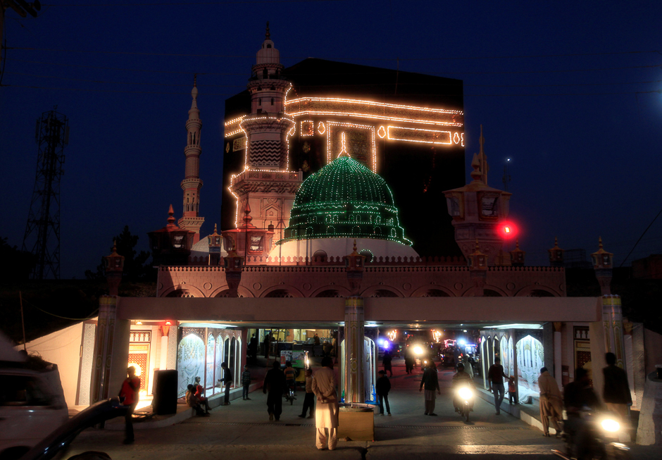 Images of the Holy Kabba in Makkah are illuminated on a street in Rawalpindi. PHOTO: REUTERS